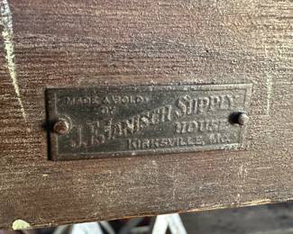 Tag on antique exam table - “JF Janisch Supply House - Kirksville, Missouri