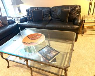 Leather sofas and brass and glass with eagle accents two tier coffee table 