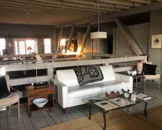 white leather couch , blanket, mid century mod end tables , art.....