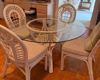 Rattan dining set, BUY IT NOW  $500 set
Table with glass top 42” round x 28” H
Four chairs with attached cushions (some stains on seat cushions, please see photos) 17.5” W x 37.25” H x 21” D
Seat height 18
