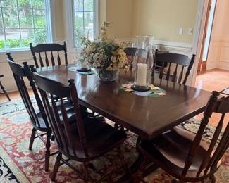 Vintage Ethan Allen 'Old Tavern'  Dining Trestle table, Table is 70” long x 35” wide x 29” high.
Two leaves measuring 15” each and table Pads are also included. This has a dark Mahogany finish. Table with 4 chairs l
Rug:Marcella Herbalwash Jaipur Rug  9' x 12' RUG 