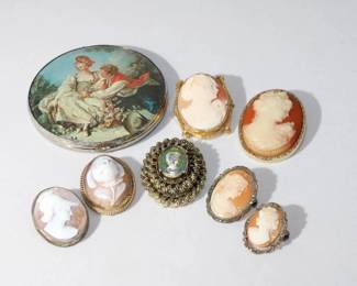 Large lot of Cameos to include gold filled, sterling, gold plated, a compact with print of well known painting made in Japan, many of cameo's with bales as well as pins two are marked for 800 sterling, 8 items in total