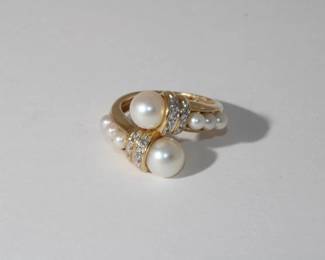 14kt yellow gold Pearl & Diamond Ring done in bypass style ring features 2 round pearls approx 7.40mm each accented by 2 rows of round diamonds next to each pearl further accented by 3 smaller pearls on each shoulder, 6.65 grams total weight, size 7