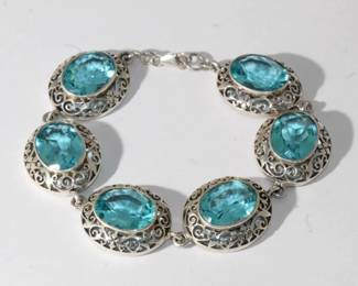 .925 Sterling Designer Blue Topaz colored stone Bracelet featuring 6 large medallions each hallmarked and marked .925 each with bezel set blue-green oval gemstone approx 10ct each bracelet measures approx 7.75" long and approx .75" wide, 34.1 grams tot
