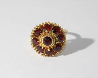 14kt yellow gold Vintage Garnet Ring, done in princess dome style featuring center bezel set round garnet surrounded by 8 round garnet approx 2ctw in heavy fancy gold mounting that weighs 8.34 grams total weight, size 8