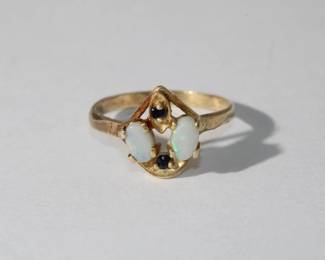 14kt yellow gold Vintage Opal & Sapphire Ring featuring 2 oval prong set opals approx .50ctw for the two with blue and orange pin fine accented by two small round sapphires, 1.7 grams total weight, size 5