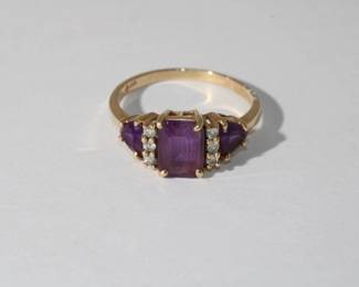 14kt yellow gold Amethyst & Diamond Ring with central prong set emerald cut amethyst approx 1.30ct with 3 round diamonds on each side followed by a trillion cut amethyst on each side, 3.0 grams total weight, size 7.5