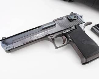 Make: Magnum Research
Model: Desert Eagle
Caliber: "Black Cherry" .50 AE
Action: Semi
Barrel: 6.25
Bore: Shiny
Serial # MR003396
Condition: Very Good
The Magnum Research Desert Eagle .50 AE, produced since 1983, is celebrated for its robust, gas-operated semi-automatic design and chambering the formidable .50 Action Express cartridge. Renowned for its precision engineering and unmistakable aesthetics, it has made iconic appearances in films and video games, marking its place in contemporary culture and firearms history. Looks to have a custom DLC coating. Comes with two magazines and a hard case. Please see photos.