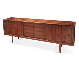 1257
Henry Walter Klein (1919-1987)
A Modern sideboard for Bramin, mid-20th century; Denmark
With sticker applied verso: Bramin / Made in Denmark / Danish Furnituremakers Control; stamped to underside of top drawer: 4987
The rosewood sideboard with opposed sliding cabinet doors, each revealing a single adjustable shelf, centering four drawers, each with a recessed pull, raised on four attenuated legs
31.75" H x 89" W x 17.75" D
Estimate: $1,500 - $2,500
