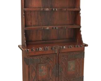 1235
Late 19th century; California
A Spanish Colonial redwood hutch
The carved wood hutch upper console with two shelves and scalloped trimming, the lower console featuring double retablo inset doors centering carved grape motifs in relief, revealing two inner shelves, with wrought iron hinges, escutcheon, and latch locks
Overall: 99" H x 60" W x 20.5" D
Estimate: $2,000 - $4,000