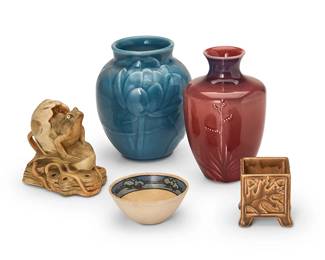 1066
Early 20th century
A group of Arts & Crafts art pottery vessels
Two marked for Rookwood, one further marked: XLVI [1946] / 6833; the other further marked: XXII [1922] / 2023; one stamped: Weller; one marked: Winfield Pasadena / 81-78; last marked 397.7.11 / S.E.S / R.B.
The glazed ceramic table items, comprising a Rookwood vase, a Rookwood smaller box planter, a Winfield vase, a Weller frog figure table item, and a Saturday Evening Girls dish with landscape band to interior rim, 5 pieces
Tallest: 6.625" H x 4.125" Dia.; Smallest: 1.625" H x 3.75" Dia.
Estimate: $200 - $400