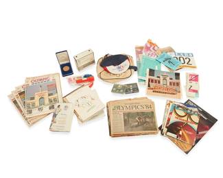 1027
1984
A collection of 1984 Los Angeles Olympics merchandise and ephemera
The collection including but not limited to various enameled commemorative pins, a commemorative medal housed in original felt box, a pair of official Olympic Bushnell binoculars, a novelty Olympic hat with secret flap message, an official Olympic vinyl handbag, six staple-bound copies of "Olympic Record: The Official Daily Start Lists and Results," the souvenir program, the program for opening ceremonies, the "Official Olympic Guide to Los Angeles," copies of Los Angeles Times newspapers, photographs, parking passes, staff meal vouchers, an identification card for David M. Davis, and other bits of related ephemera
Estimate: $600 - $800