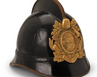 1133
Early 20th century
A German pre-war fireman helmet
Badge reads: Gott Zur / Ehr, Dem Nachstem / Zur Wehr
The metal and leather helmet with brass trim, central fin, and front and rear visors, featuring a gilt-metal badge bearing Masonic symbols including the all-seeing eye and handshake, the interior with leather webbing and chinstrap
8" H x 7.5" W x 10.5" D
Estimate: $400 - $600