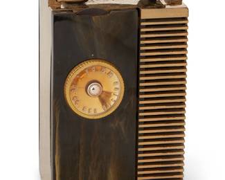 1096
1947
An RCA "The Solitaire" model 54B5 tube radio
Dial marked: RCA Victor; serial number to paper inset: B 001747; marked to interior: KC 1947 / B274 / 94186-504
The four-tube personal portable radio with 6-channel AM tuning dial, volume dial, and on/off switch under the rubber handle, housed in a gold-plated metal case with marbled Catalin cabinet housed in original felt bag, electrified
7" H x 4.5" W x 3.25" D
Estimate: $300 - $400