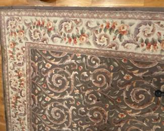 8 ft X 10 ft tufted carpet in beautiful shades of olive, rose, cream, taupe and amber. Showing some use, but is still lovely.