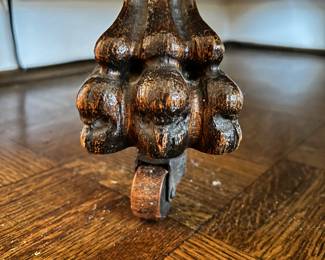 View of wood casters of curio cabinet