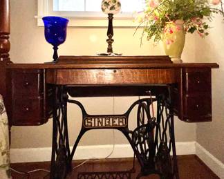 Antique Singer sewing machine in hide-away cabinet