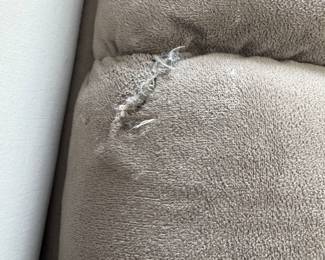 The sofa has one small tear that can be easily fixed
