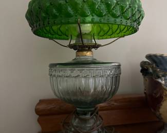 Green glass oil lamp.  Has some damage