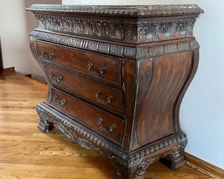 Ornate chest of drawers with stone top