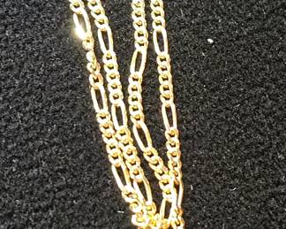 14k gold figaro link necklace close up of link 