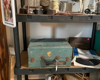 Antique irons, juicer, tins, jars, record player, roller skates with wooden wheels
