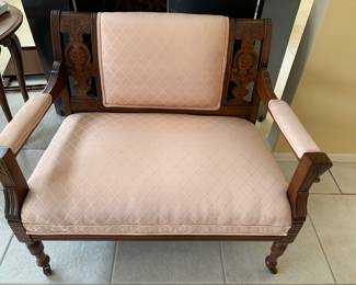 Beautifully carved loveseat with custom upholstery.