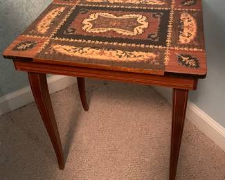 Inlaid table that has a music box underneath