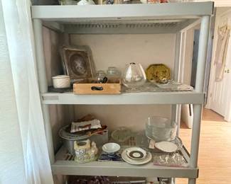 Shelf filled with canisters, crystal, linens, smalls...