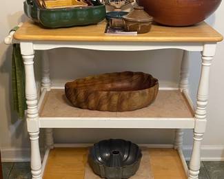 White/wood rolling island with wood bowls...