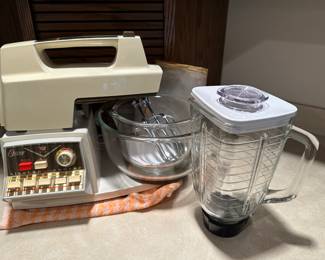 This is the coolest piece. This is a vintage Oster Imperial Kitchen Center! It was made in the mid 20th century 1950s and 60s and it combines a mixer with many attachments for multiple kitchen functions!