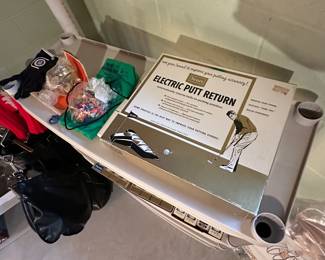 This is the shelf of golf items. The top has an electric put Return device!