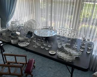 In the living room, we have a table full of cut, crystal and cut glass
