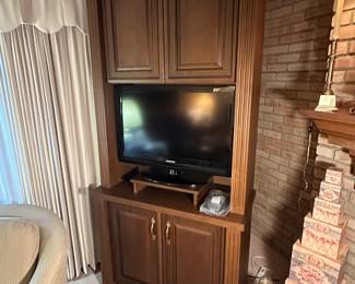 This is a beautiful large TV center! It has a large cupboard space above and below the TV!