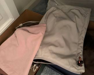 These two boxes are filled with hoods and hats that go with the coats hanging above