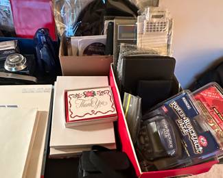 The top right box is a box of vinyl record albums. The rest are assorted office supplies.