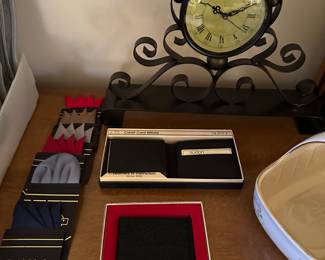 Here are some vintage pocket, squares and leather wallets a very cool little wrought iron clock in the back