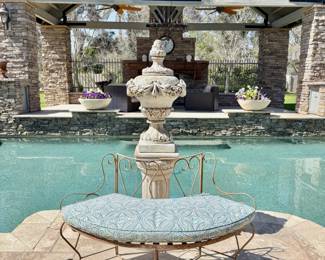 Stone garden urn on pedestal with arched bench