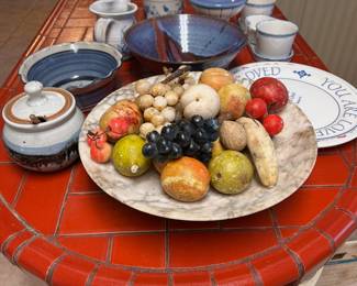 a bowl of stone fruit, signed pottery