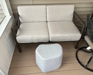 Really neat loveseat for patio, along with a heavy sculptured table.