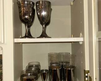 Mid century modern drink ware (set of eight and a set of three), and silver chalices. Small glasses etched with airplanes. Taller glasses come out of the silver cup. Really fun matching set of glasses! 