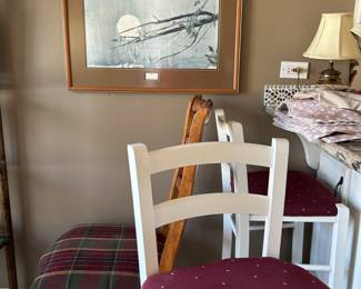 Beautiful framed photograph, two red barstools. 