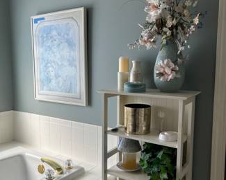 Beautiful impressionist color palette painting, along with a beautiful flower vase and multiple candles. 