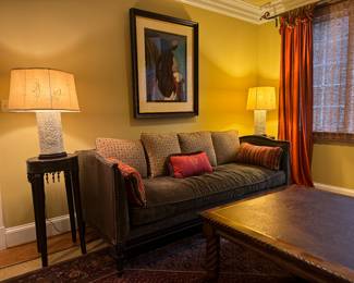 Lilian August Green Upholstered Sofa with Leather Shell Sofa (37"D x 84"W x 34" Back Height) & Large Square Mahogany Base with Leather Top Coffee Table (48"W x 48"D x 18"H) & Tall Rattan Top with Bead Accented Round Side Table (15"D x 32"H / Pair) & Vintage Blanc De Chine Porcelain Pierced Table Lamp (Pair)