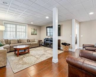 Coffee table, west elm floor lamp, and large pottery barn brown leather chairs