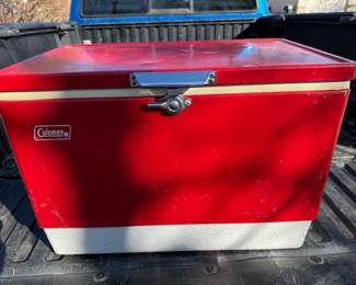 Metal. 1976 Coleman cooler. Bottom is intact, no cracks.