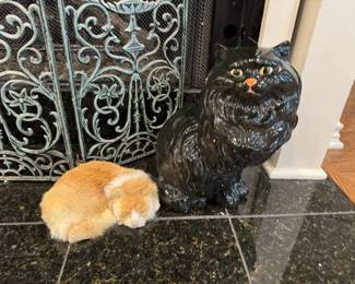 Adorable plaster cat and sweet fur sleeping kitty.