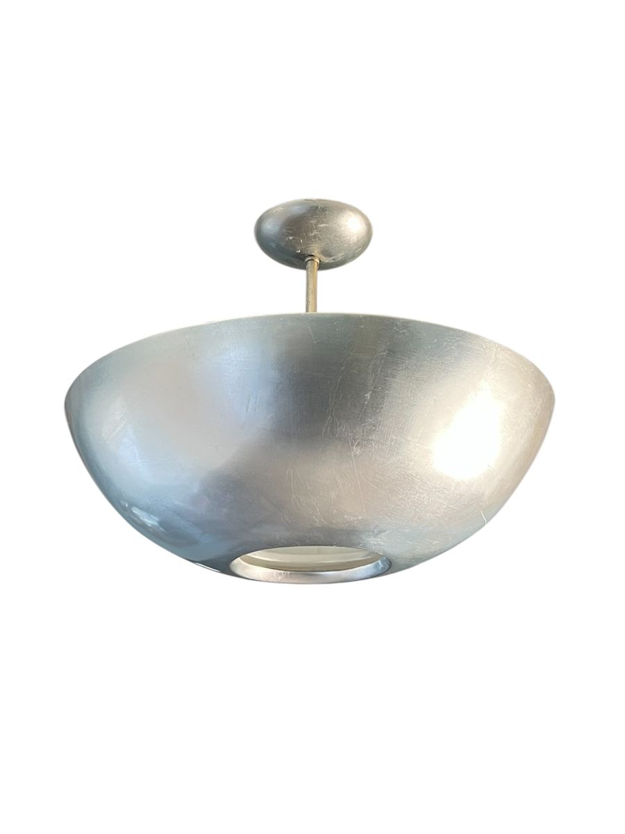 A large vintage plafonnier in modern style with an inverted half dome shape, silver leaf finish and a light diffuser at base.