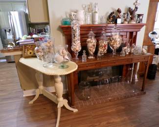 Lots of seashells in glass containers and furniture