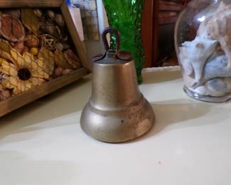 Brass bell, with a large x on each side. The ringer part is made of one piece, very different